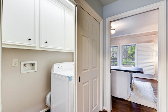 laundry area with dark wood-type flooring, cabinets, and washer / clothes dryer