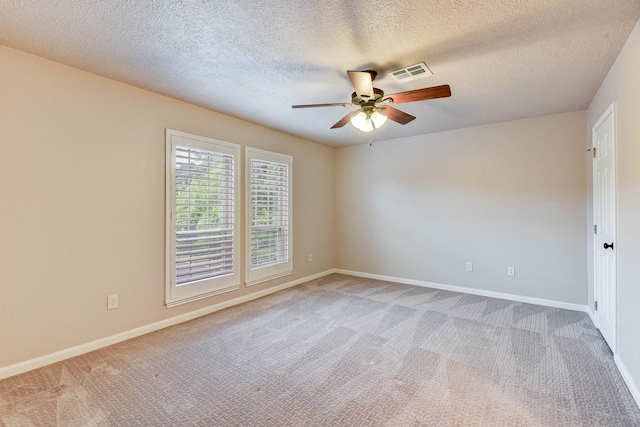 spare room with light carpet, a textured ceiling, and ceiling fan