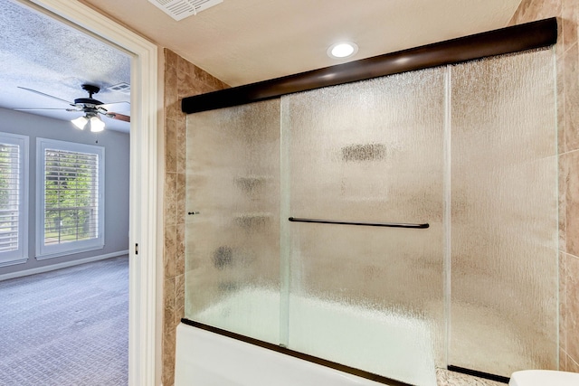 bathroom with ceiling fan, a textured ceiling, toilet, and an enclosed shower