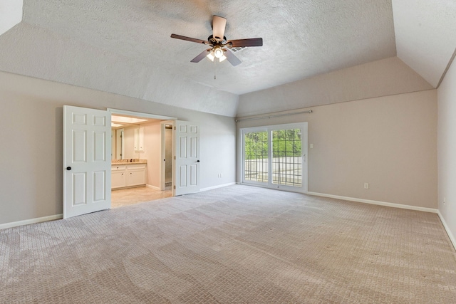 interior space featuring light carpet, ceiling fan, access to exterior, and vaulted ceiling