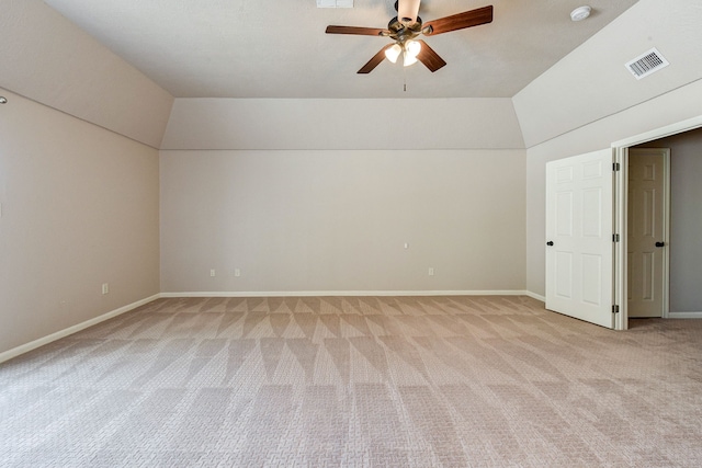 additional living space with lofted ceiling, light carpet, and ceiling fan