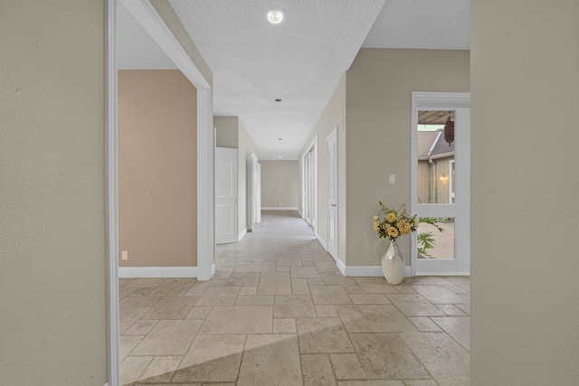 hallway featuring a textured ceiling