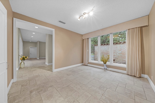 spare room featuring a textured ceiling