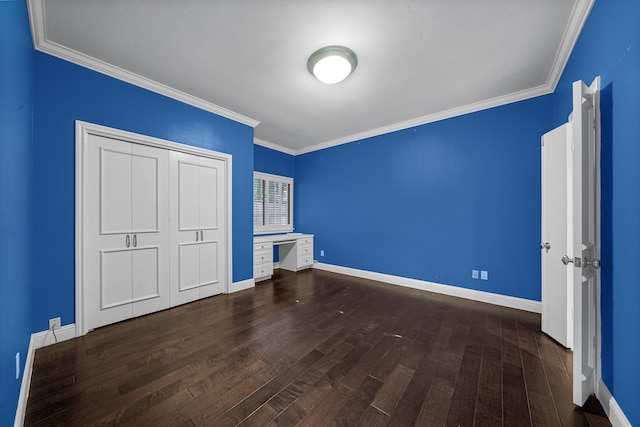 unfurnished bedroom featuring ornamental molding, a closet, and dark wood-type flooring