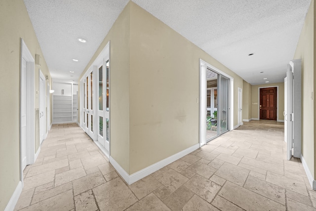 corridor featuring a textured ceiling