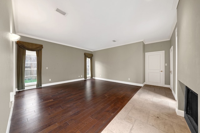 unfurnished living room with wood-type flooring and ornamental molding