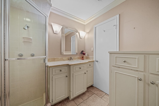 bathroom featuring vanity, a shower with shower door, and crown molding