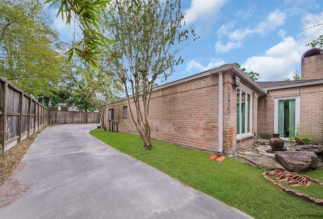 view of home's exterior featuring a patio area and a yard