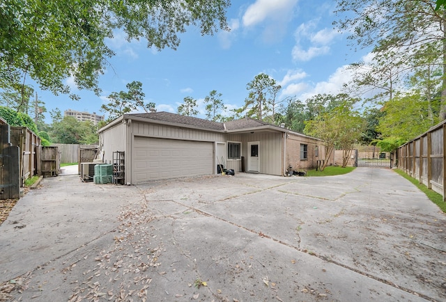 rear view of property featuring a garage