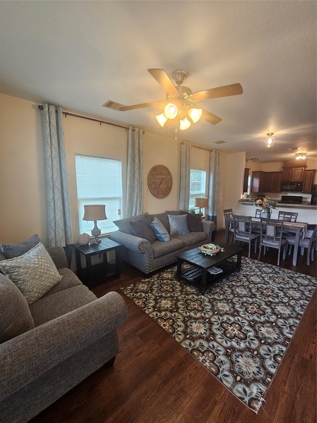 living room with hardwood / wood-style flooring and ceiling fan