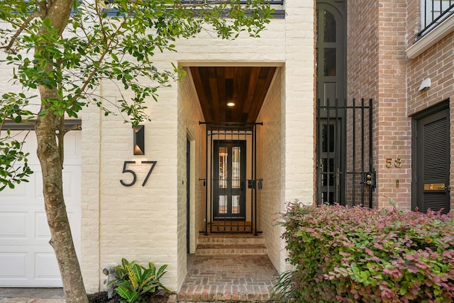 view of exterior entry with a garage