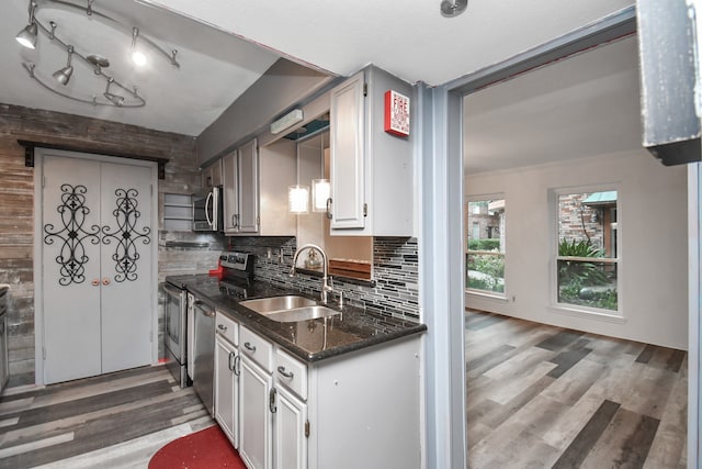 kitchen featuring white cabinets, backsplash, sink, and appliances with stainless steel finishes