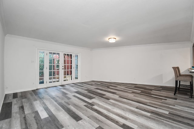 unfurnished room with wood-type flooring, ornamental molding, and french doors