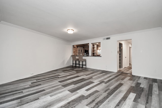 interior space featuring crown molding and hardwood / wood-style flooring