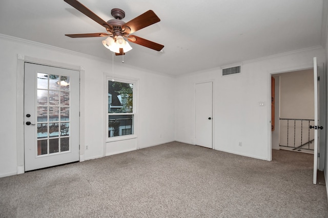 carpeted empty room featuring ceiling fan and crown molding