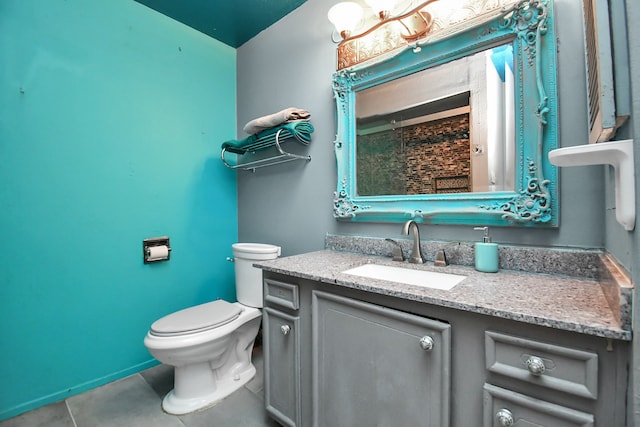 bathroom featuring tile patterned flooring, vanity, and toilet