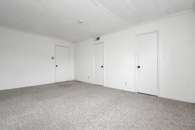 carpeted spare room with crown molding