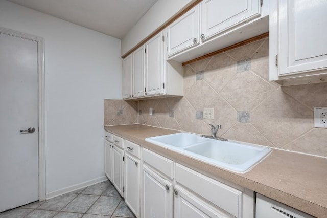 kitchen featuring white cabinetry, sink, tasteful backsplash, and light tile patterned floors