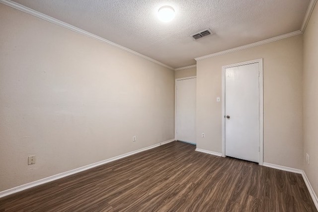 spare room with ornamental molding, dark hardwood / wood-style flooring, and a textured ceiling