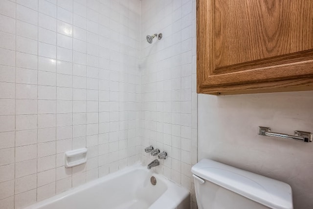 bathroom featuring tiled shower / bath and toilet