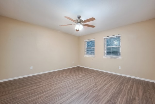 empty room featuring hardwood / wood-style floors and ceiling fan