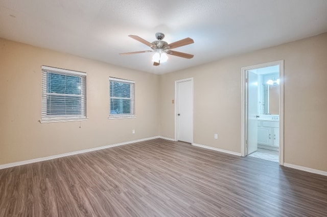 empty room with hardwood / wood-style floors and ceiling fan