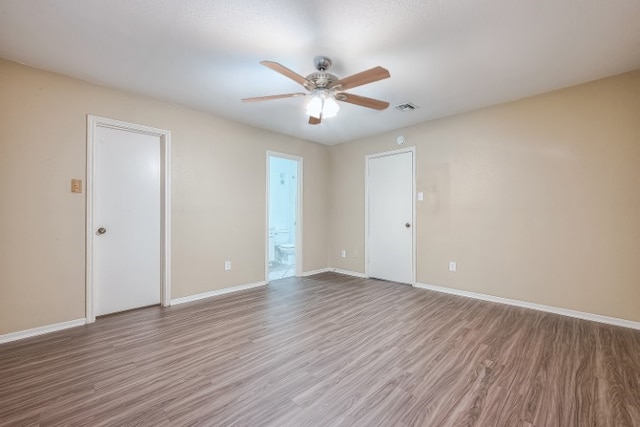 unfurnished room with wood-type flooring and ceiling fan