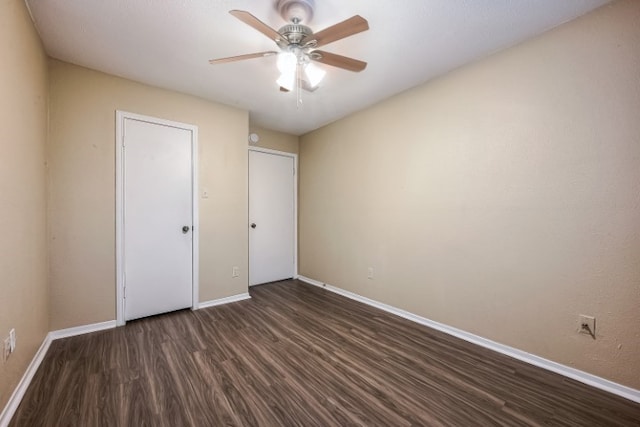 unfurnished bedroom featuring dark hardwood / wood-style flooring and ceiling fan