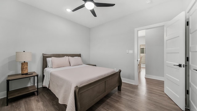 bedroom with ceiling fan and dark hardwood / wood-style flooring