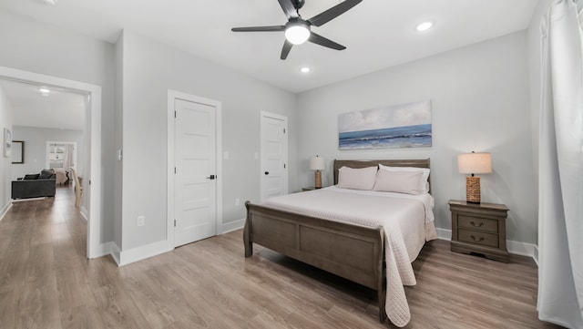 bedroom with ceiling fan and light hardwood / wood-style floors