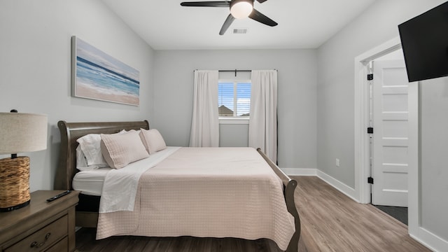 bedroom with hardwood / wood-style floors and ceiling fan