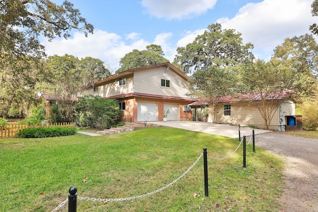 front facade featuring a garage and a front lawn