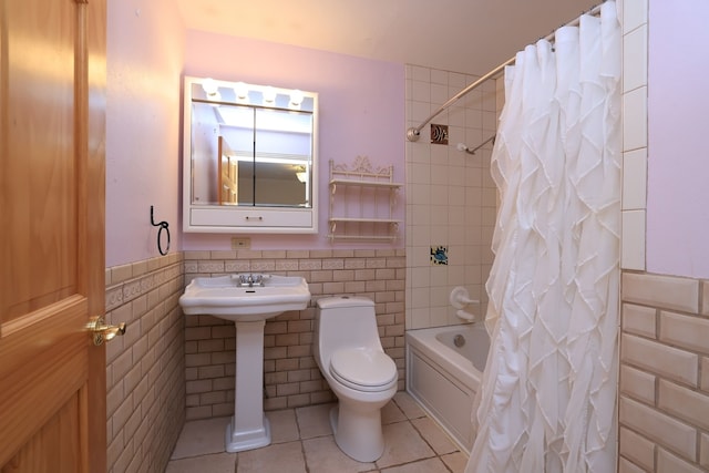 full bathroom with sink, shower / bathtub combination with curtain, tile patterned floors, toilet, and tile walls