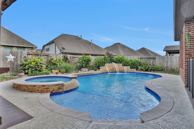 view of pool with an in ground hot tub and pool water feature