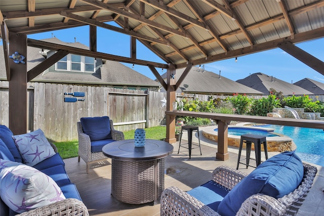 view of patio / terrace featuring a gazebo, a fenced in pool, and an outdoor hangout area