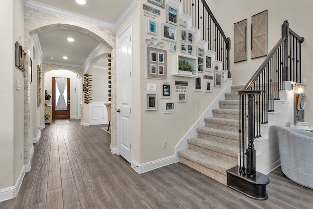 staircase featuring hardwood / wood-style flooring and ornamental molding