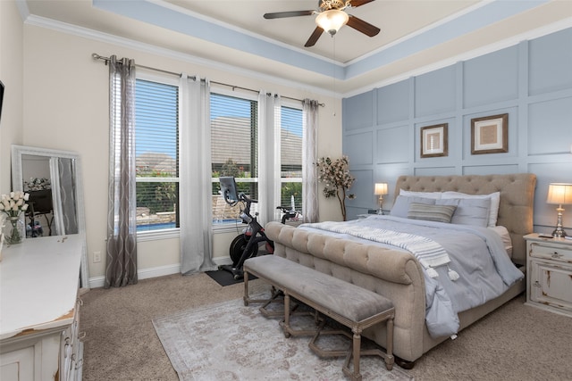 carpeted bedroom featuring crown molding and ceiling fan