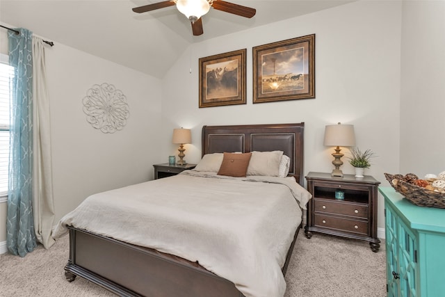 bedroom with vaulted ceiling, light colored carpet, and ceiling fan