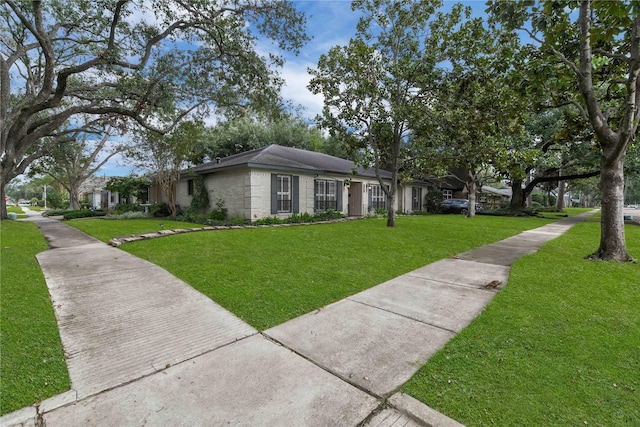 ranch-style home with a front lawn