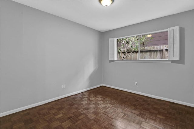 empty room featuring dark parquet flooring