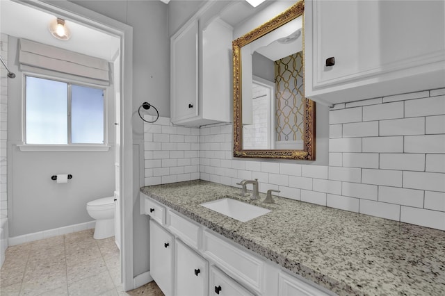 bathroom featuring vanity, tile patterned flooring, decorative backsplash, and toilet