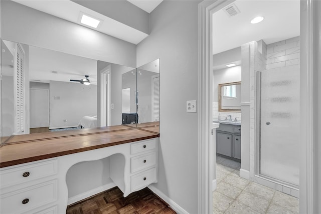 bathroom featuring walk in shower, tasteful backsplash, parquet floors, vanity, and ceiling fan