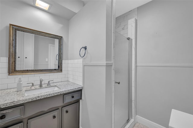 bathroom with an enclosed shower, backsplash, and vanity