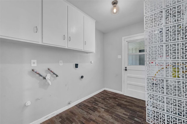 clothes washing area with gas dryer hookup, cabinets, and hookup for an electric dryer