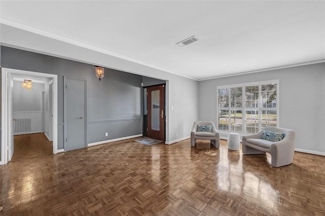 living area featuring ornamental molding and dark parquet flooring