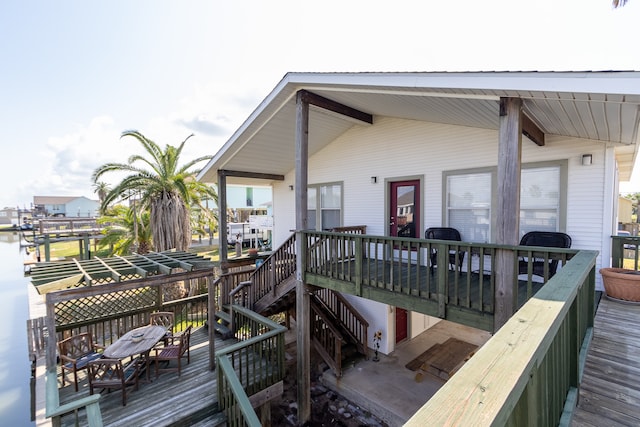 wooden terrace featuring a water view