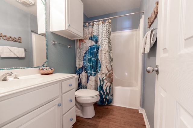 full bathroom featuring vanity, shower / bath combo with shower curtain, hardwood / wood-style flooring, and toilet