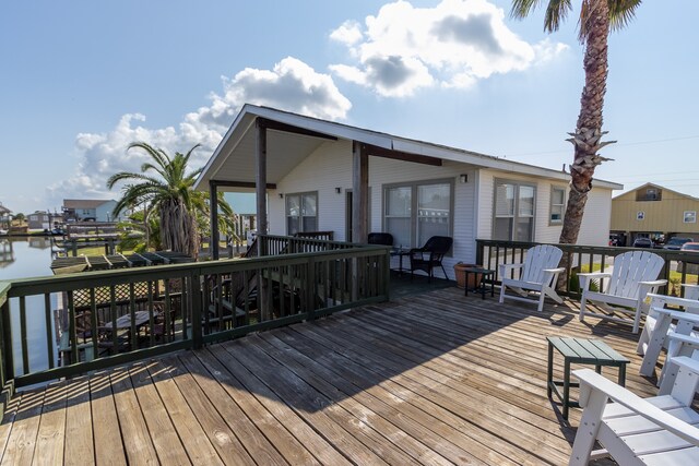 wooden terrace featuring a water view