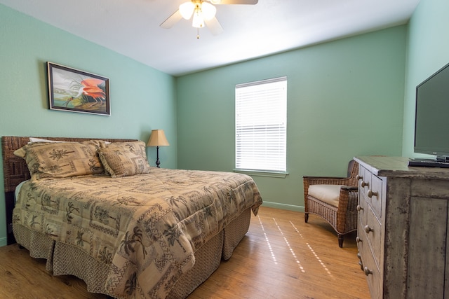 bedroom with light hardwood / wood-style floors and ceiling fan