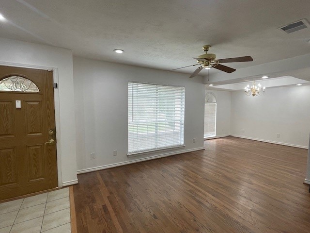 foyer entrance featuring hardwood / wood-style floors and ceiling fan with notable chandelier